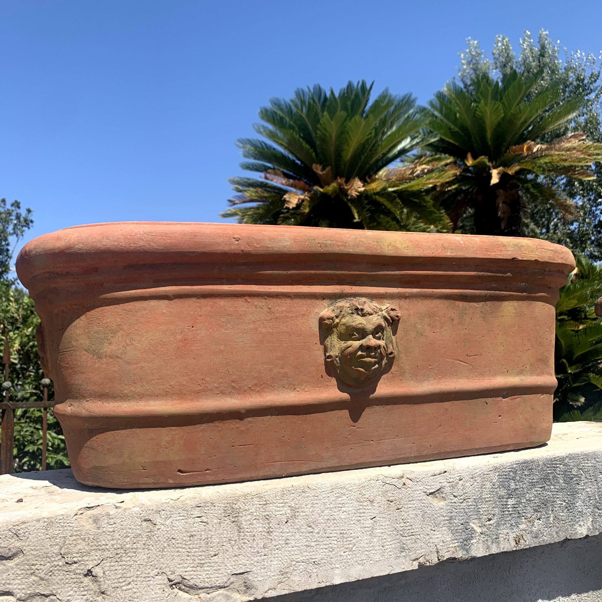 Terracotta vase with mask