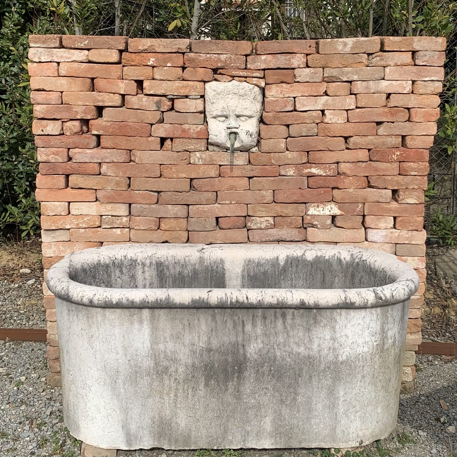 White stone wall-mounted bathtub